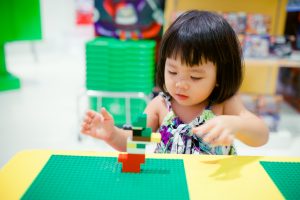 Young child playing with blocks in a preschool classroom