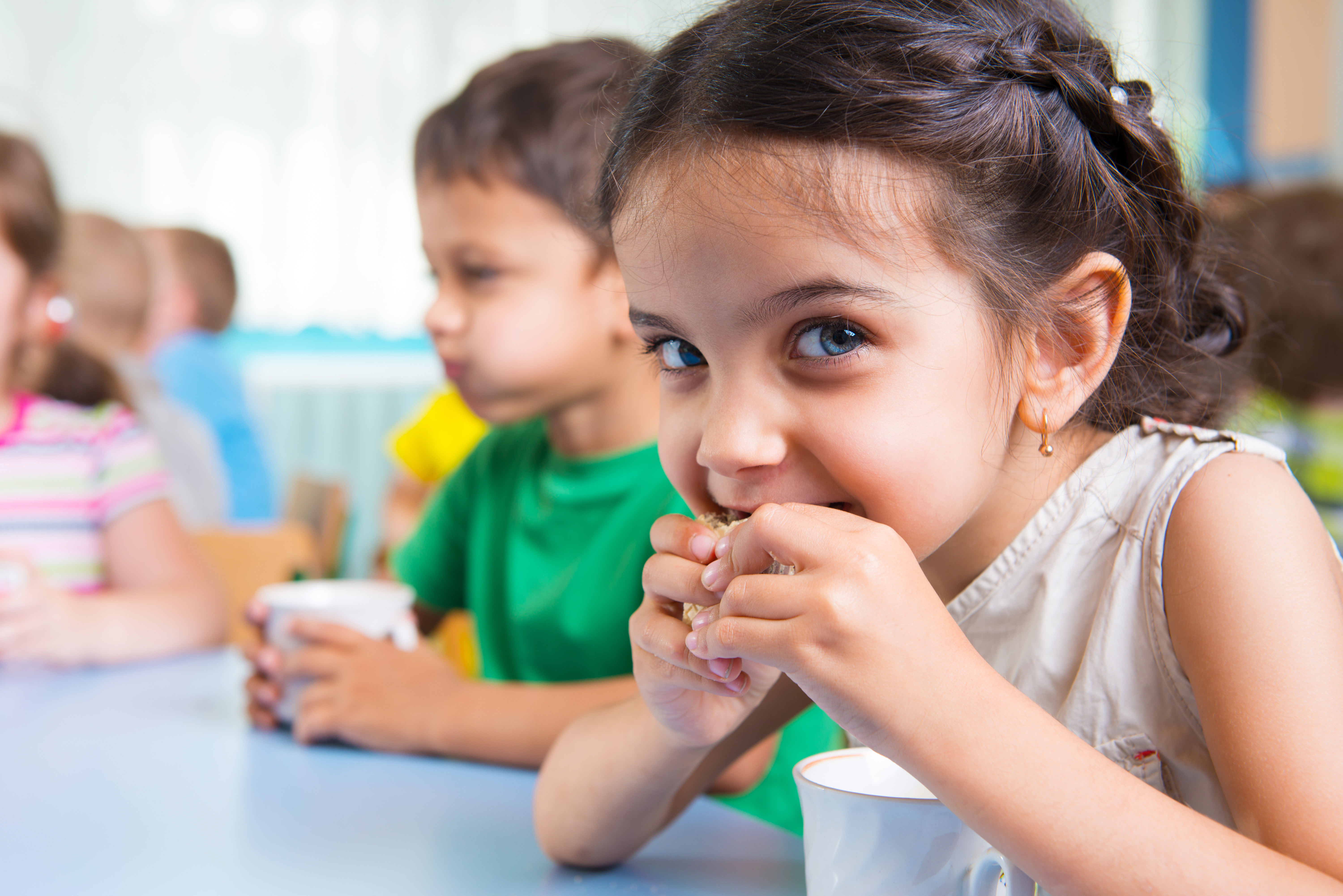 Young children drinking milk at daycare